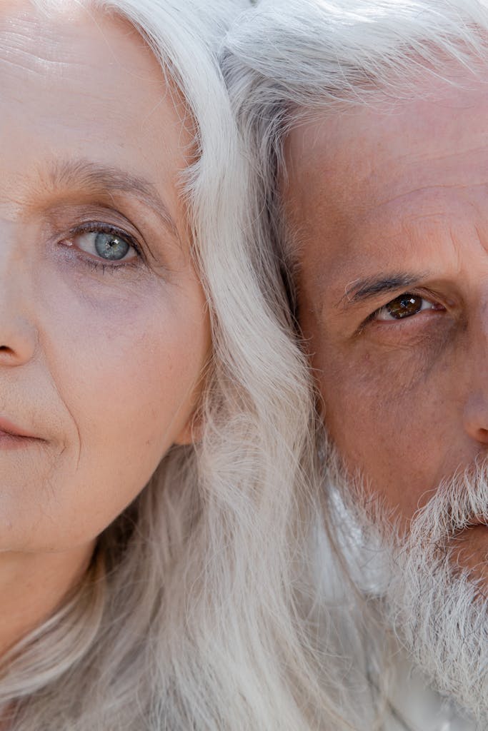 A detailed close-up image showing the half faces of an elderly couple with gray hair.